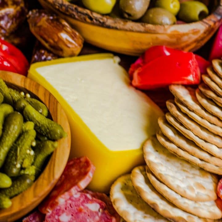 Close up of a wedge of cheese on a cheese board.