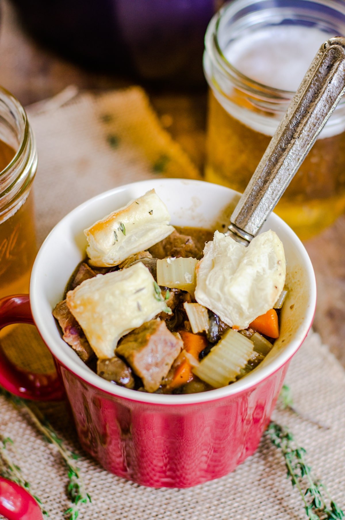 Inside of a mug of soup with puff pastry croutons.