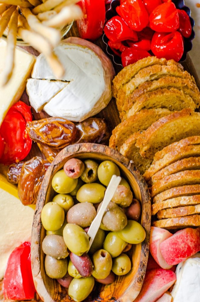 Olives and other charcuteries in a tray.