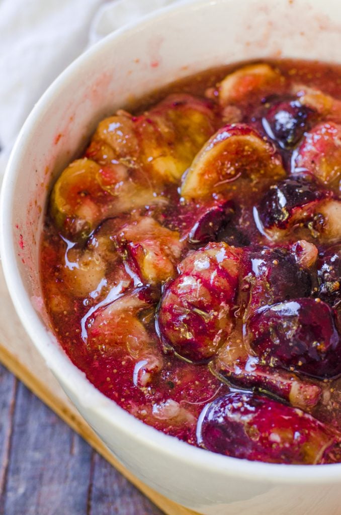 Macerated figs in a white bowl ready to turn into jam.