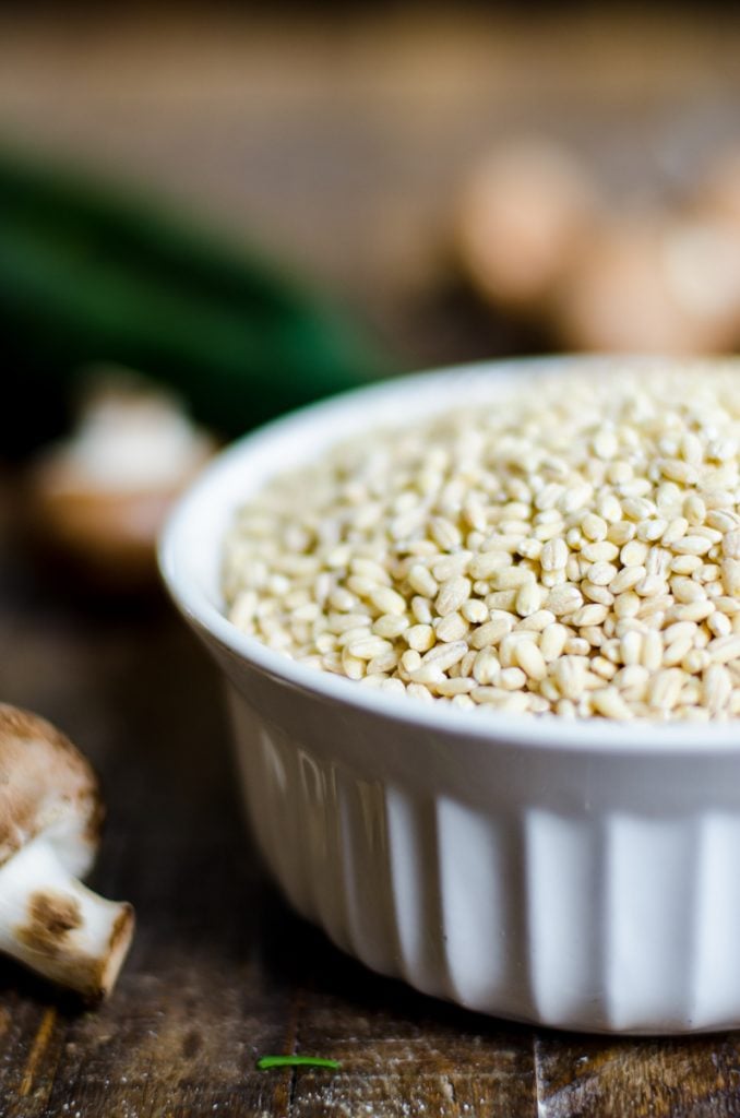 close up of a white bowl filled with pearled barley.