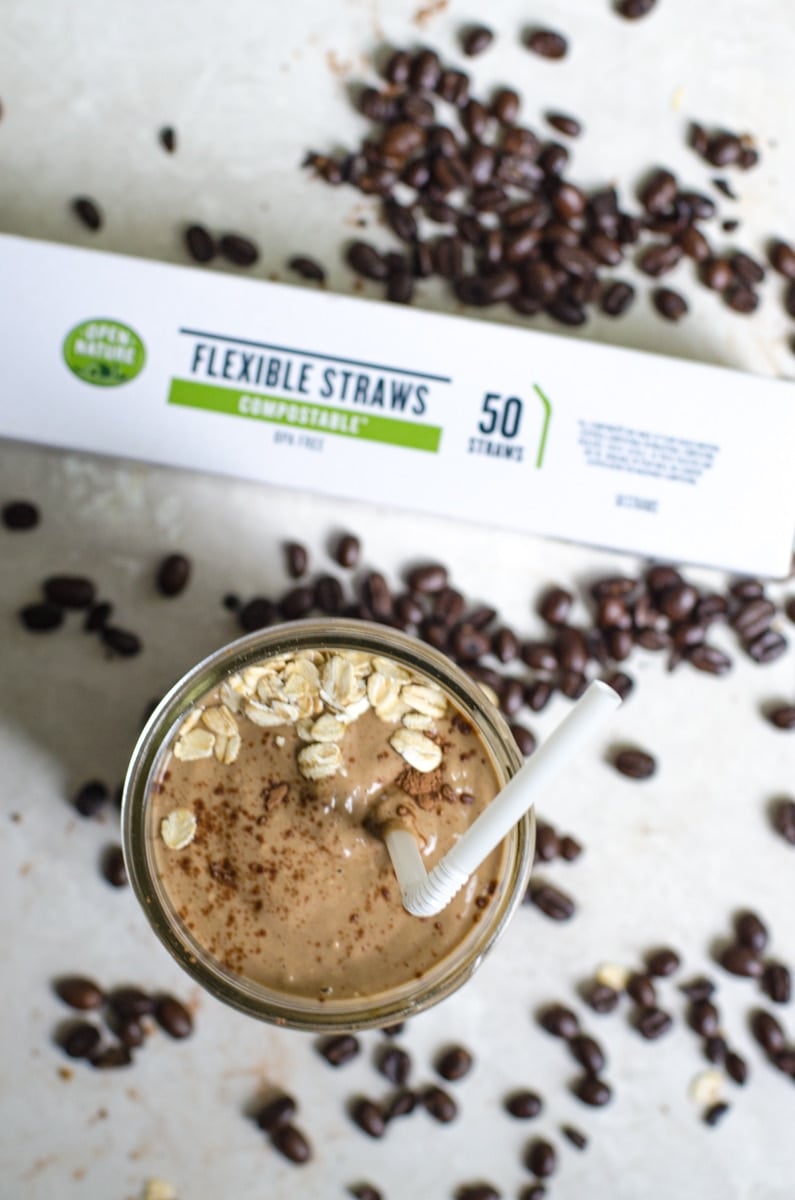 A coffee smoothie next to a box of compostable straws.