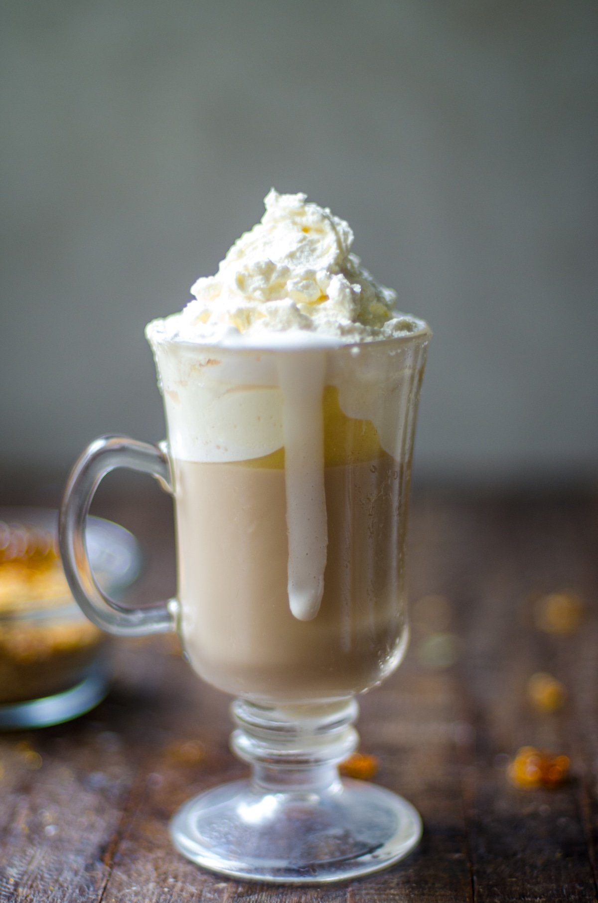 Melting whipped cream dripping down side of mug.