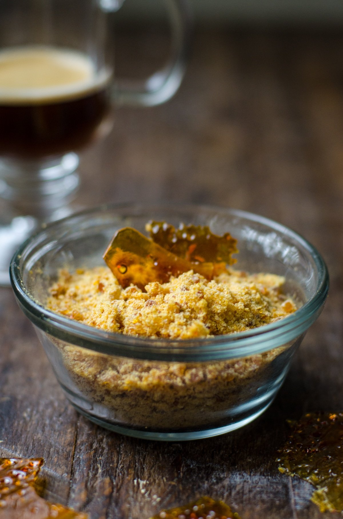 Clear bowl filled with crushed bruleed sugar. 