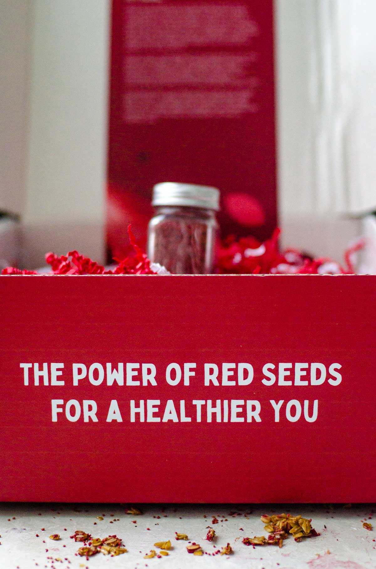 A red box that says "the power of red seeds for a healthier you" with a container of cranberry seeds coming out.