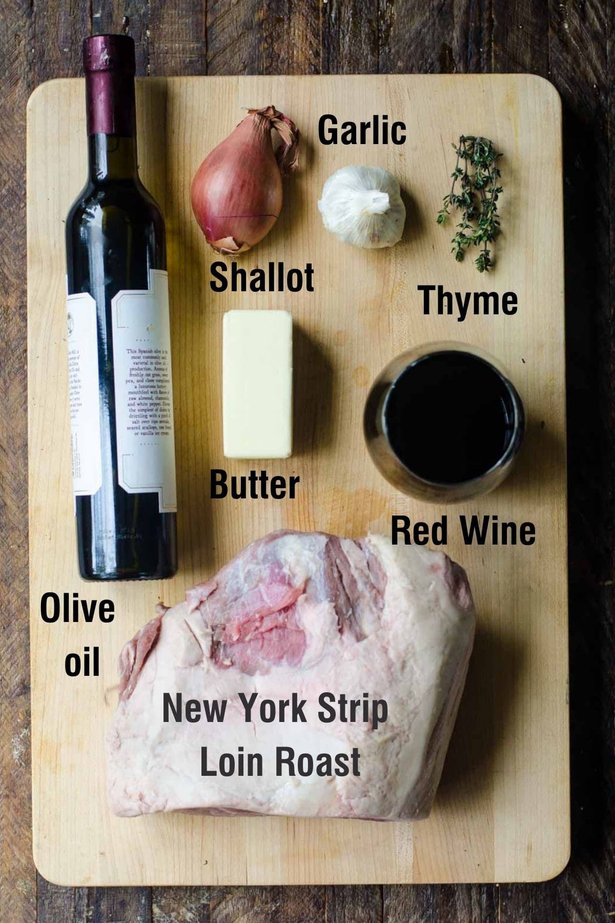 Ingredients on a cutting board for making new york strip roast.