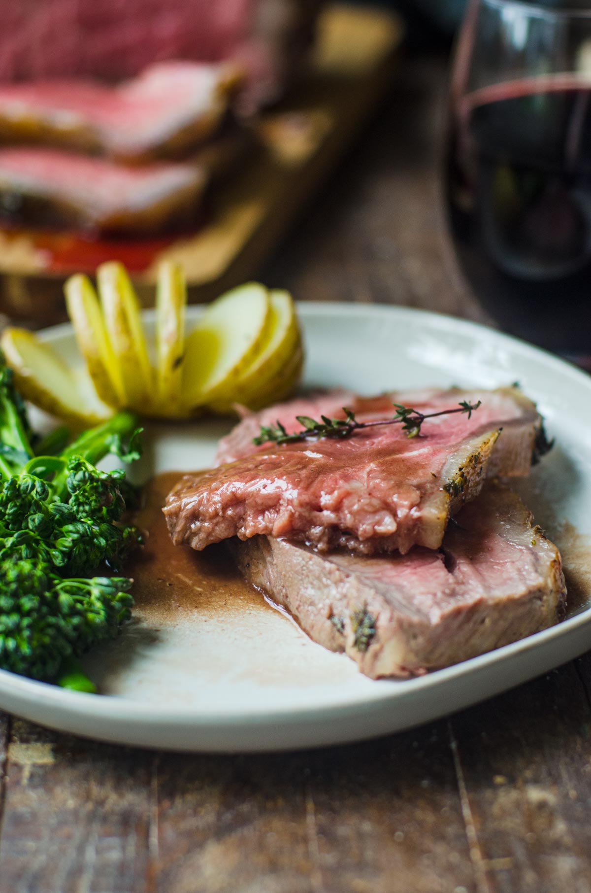 A dinner plate of strip roast with red wine.