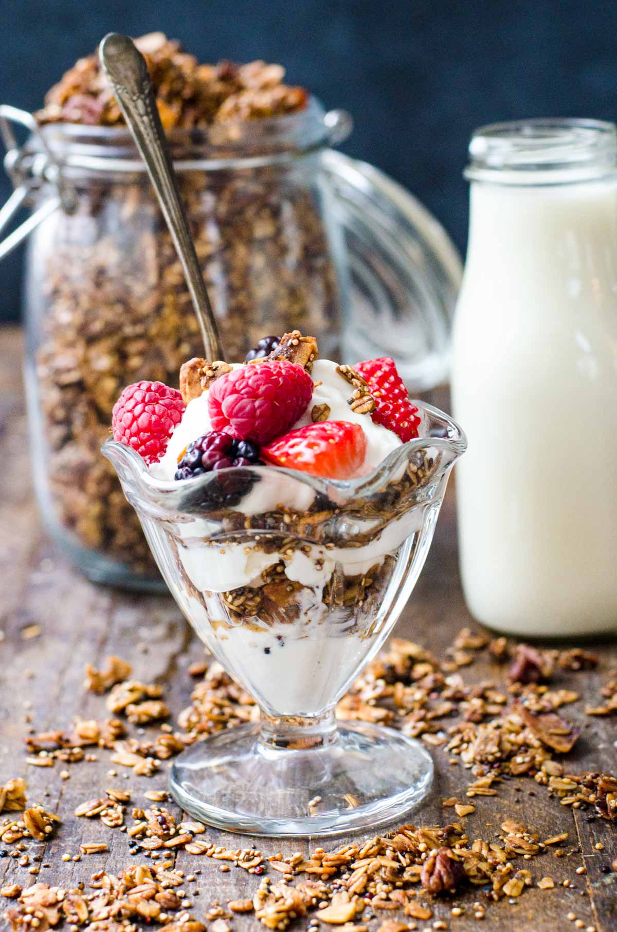 A yogurt and granola parfait topped with berries.