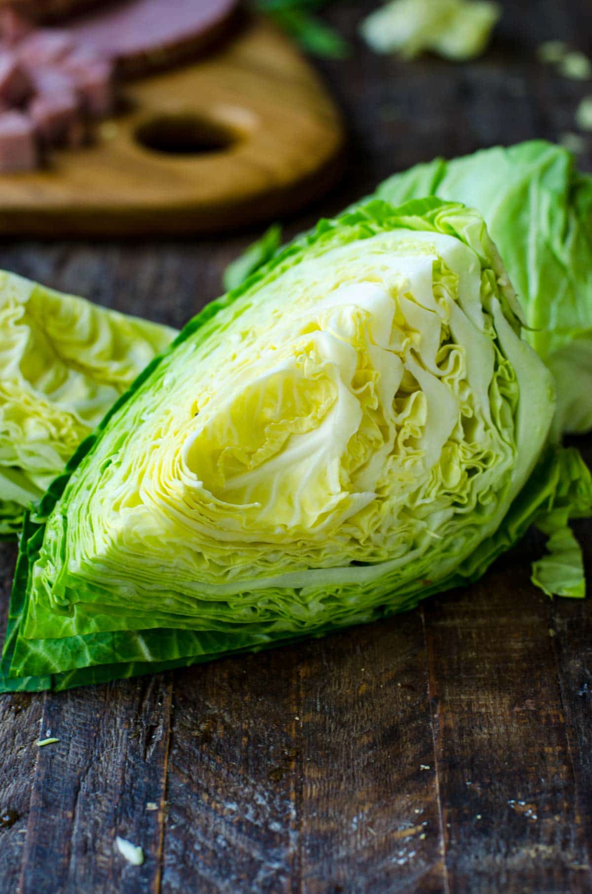 Close up of details of a cut and cored head of green cabbage.