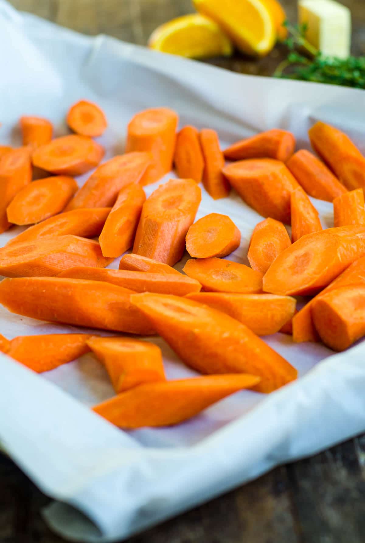 A sheet pan of carrots cut on a bias for roasting.