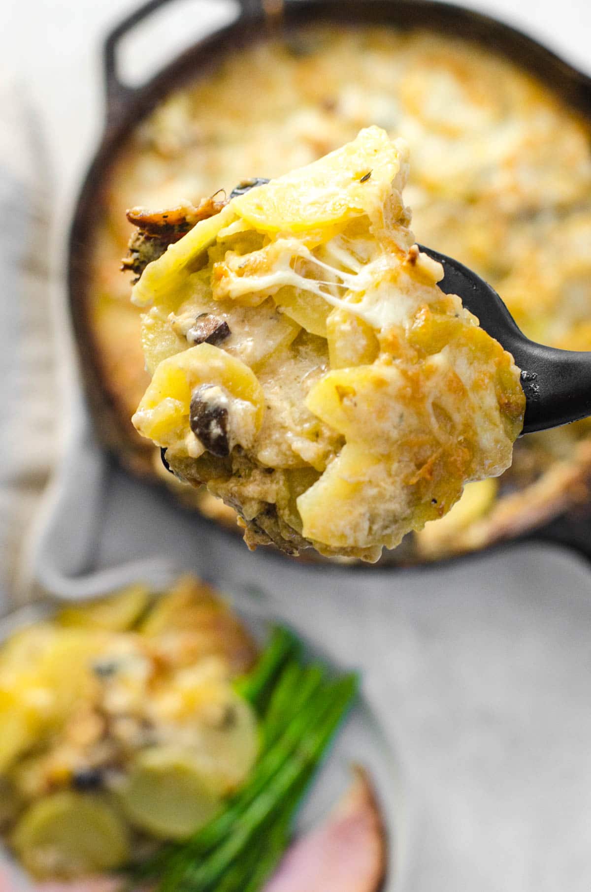 A spatula lifting out Scalloped Potatoes with Mushroom Soup
