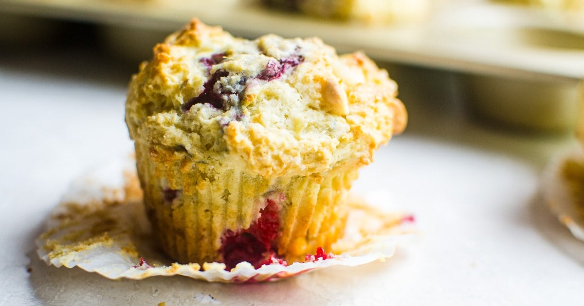 Close up of an unwrapped raspberry muffin.