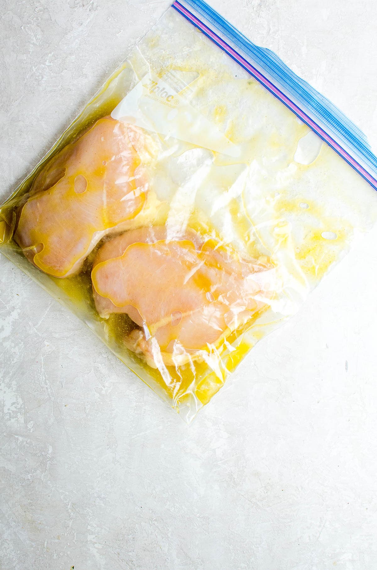 A bag of marinating chicken breasts.