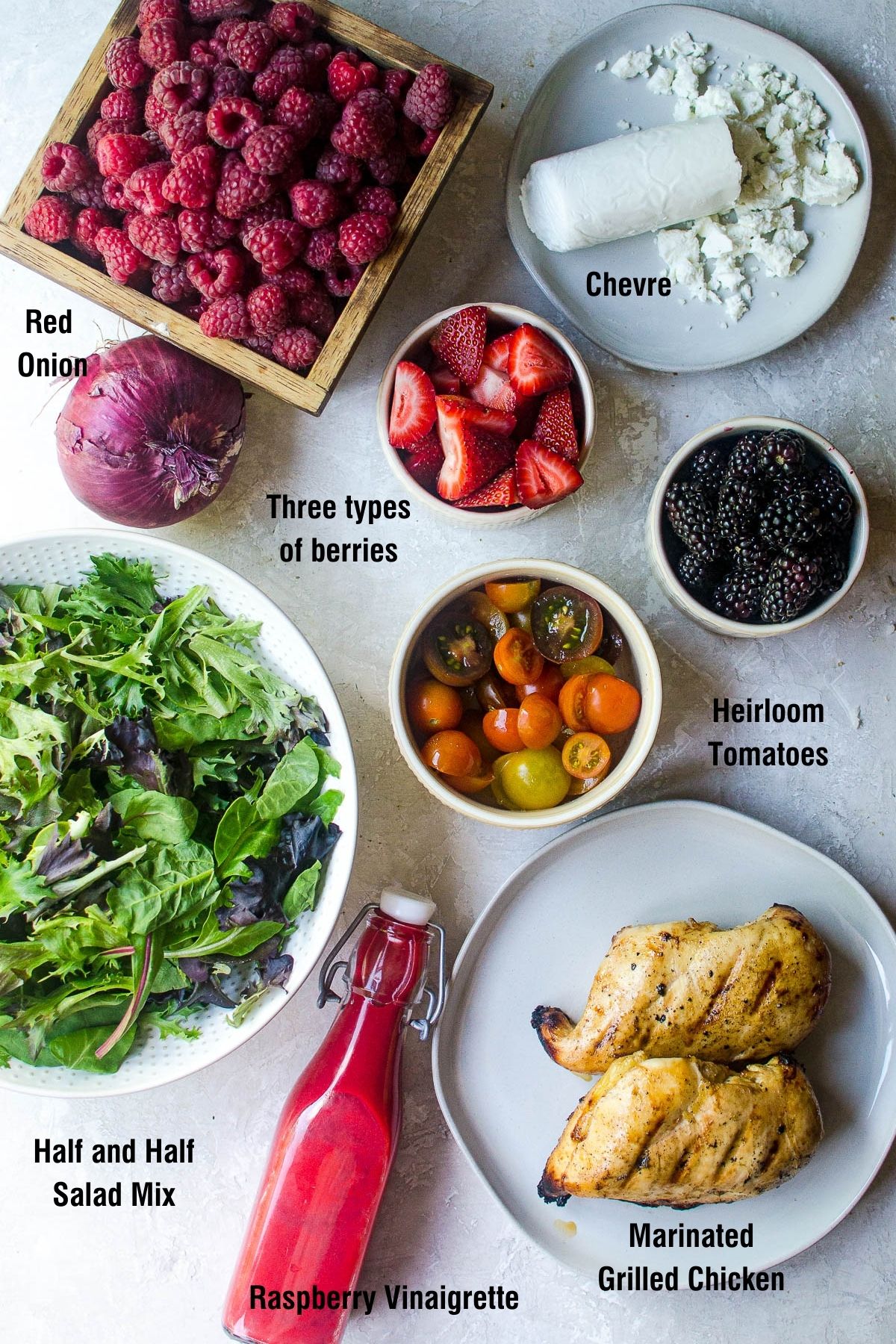 Labeled ingredients for making a summer berry salad.